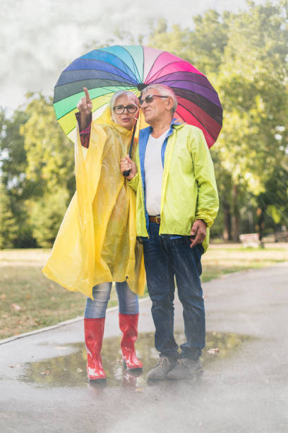 istock Couple with a rainbow umbrella 1050238260