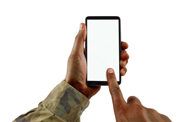 the military communication Man hand is holding a white modern smart phone with uniform military against a white background and copy space. black military man stock pictures, royalty-free photos & images