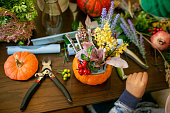 How to make a Thanksgiving centerpiece with big pumpkin and bouquet of flowers.