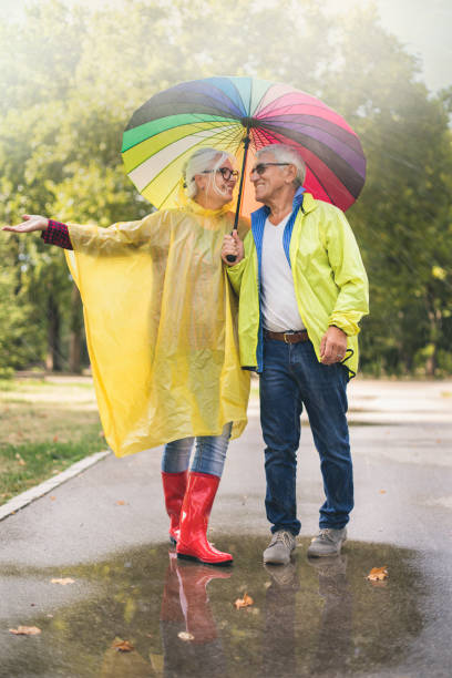 istock Couple with a rainbow umbrella 1050239388