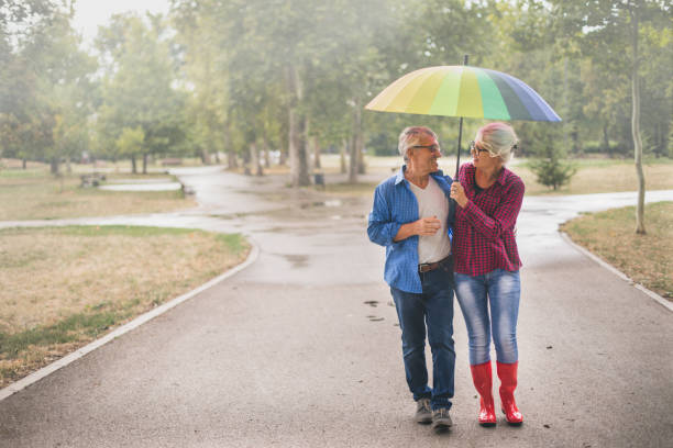 istock Couple with a rainbow umbrella 1050241280