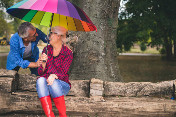 istock Two people with umbrella in autumn rainy day 1050242492