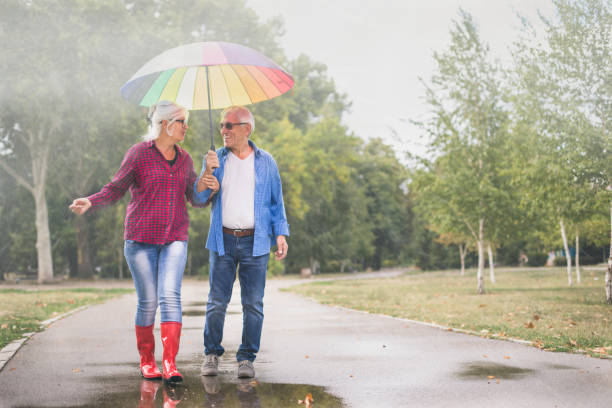 istock Couple with a rainbow umbrella 1050245616