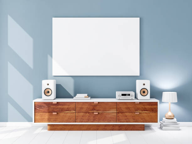 istock Horizontal white canvas Mockup hanging on the Blue wall with hi-fi micro system on bureau, lamp on the floor with books 1050245750