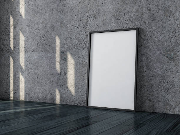 istock Poster with Black Frame Mockup standing near concrete wall on the floor 1050245758