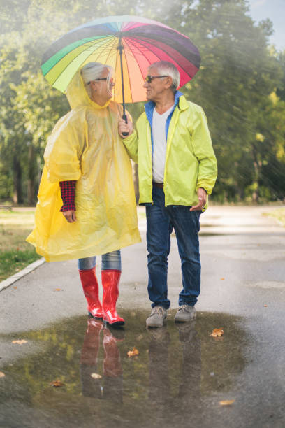 istock Couple with a rainbow umbrella 1050245804