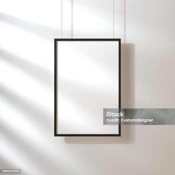 White Poster With Black Frame Mockup Hanging On The Wall With Shadows Stock Photo - Download Image Now