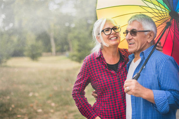istock Couple with a rainbow umbrella 1050246062