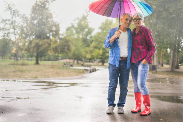 istock Couple with a rainbow umbrella 1050247416