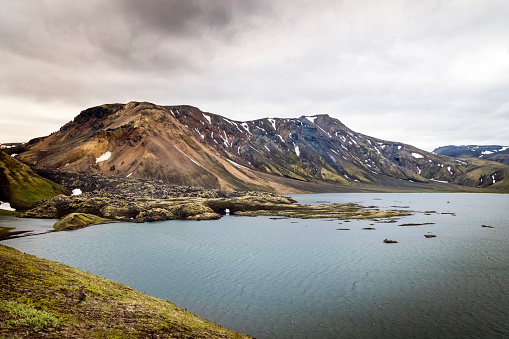Idyllic shot of Frostastadavatn lake against sky at Fjallabak Nature Reserve. Scenic view of mountains in wilderness area. This place is famous for nature loving tourism in highland of Iceland.