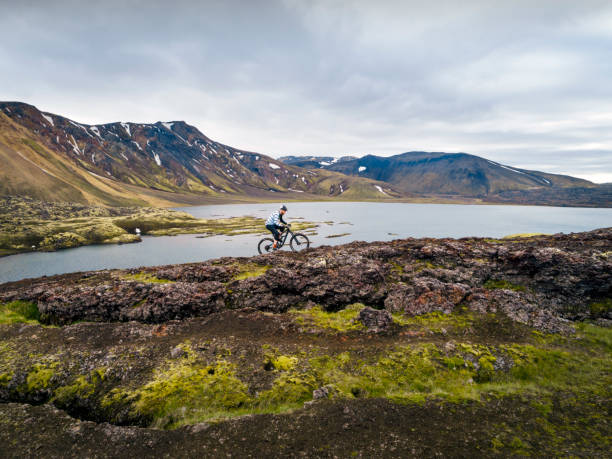 istock Man cycling at in extreme volcanic nature. 1050248748