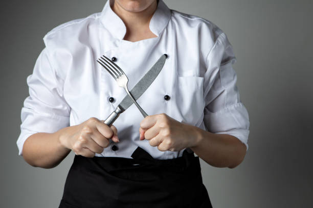 istock chef hand fork knife cooking prepare  food  in kitchen restaurant 1050249034