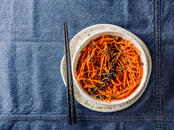 istock Raw carrot noodles or spaghetti, top view 1050267754