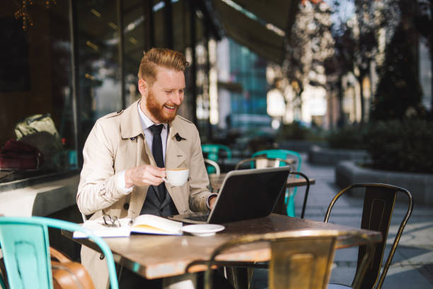 istock Cheerful entrepreneur drinking coffee at a cafe while working 1050270824