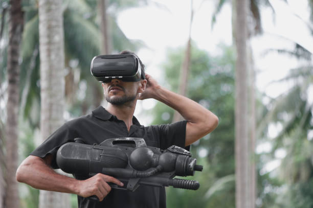 istock Man in virtual reality headset playing video game outdoors 1050274194
