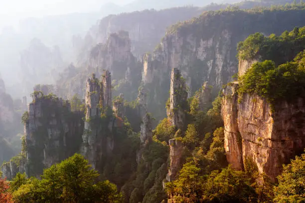 Iconic quartzite sandstones pillars & peaks in Wulingyuan / Zhangjiajie National Forest Park in Hunan Province, China. Unique mountain landscape inscribed as UNESCO World heritage site.