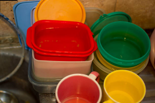 Plastic dirty utensils in the sink for cleaning and washing