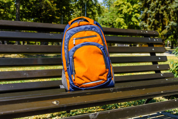 istock Tourist backpack on a bench in city park 1050280400