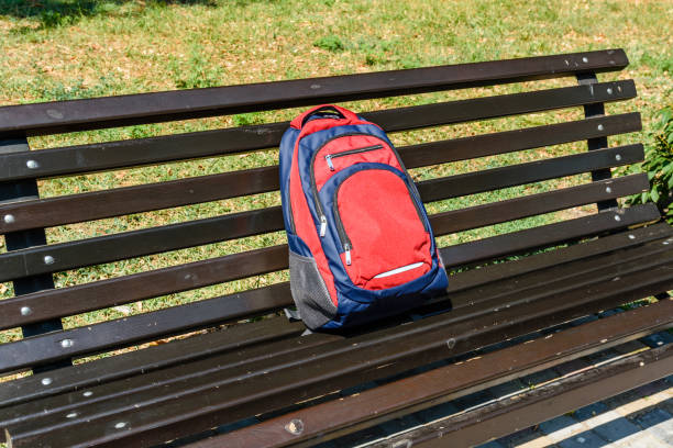 istock Tourist backpack on a bench in city park 1050280402