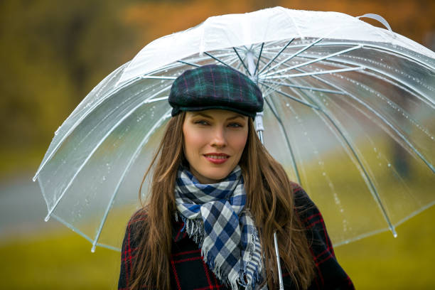 istock Happy woman holding an umbrella 1050280740
