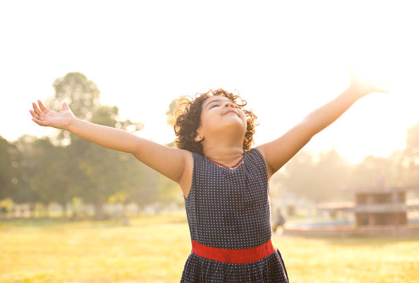 istock Girl with arms outstretched at park 1050283674