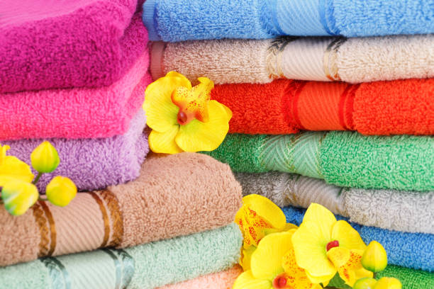 istock Colorful towels stacks and flowers 1050284280