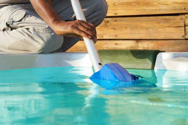 istock Hotel staff worker cleaning the pool 1050284612
