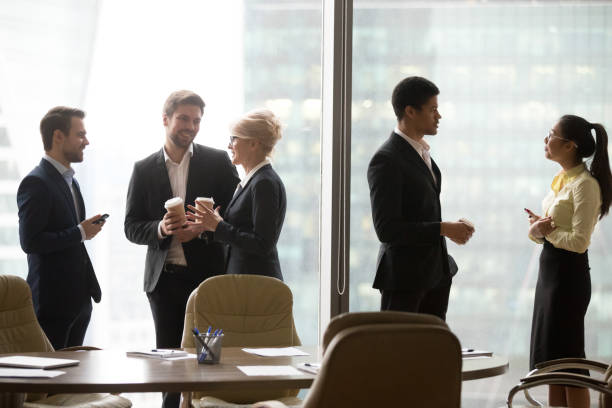 istock Multiracial, business people talking in break and drink coffee 1050287428