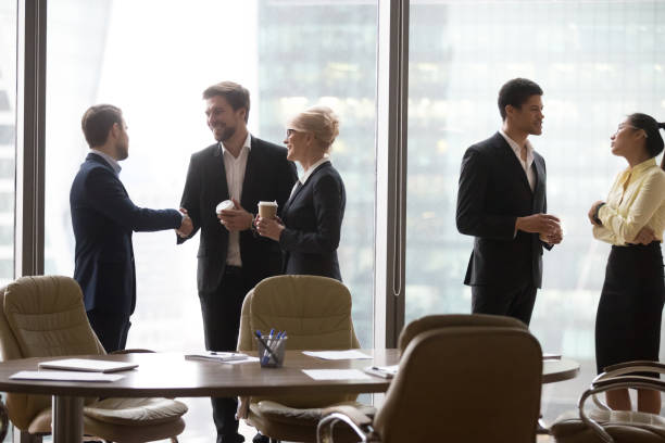istock Multiracial, business people talking in break, drink coffee 1050287436