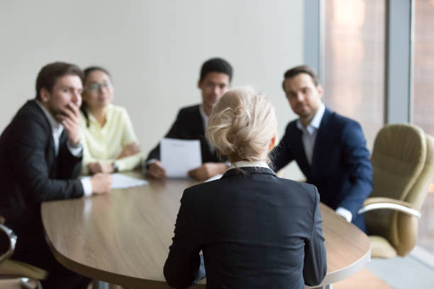istock Woman passing job interview at office, interviewers on backgroun 1050287466