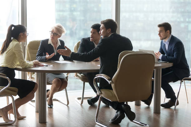 istock Multiracial team group disputing in office boardroom at meeting 1050287494