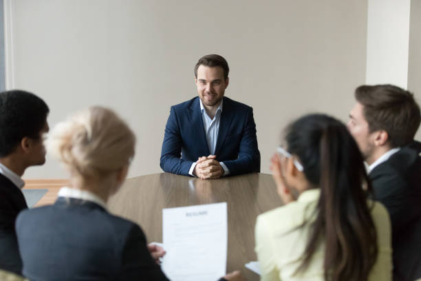 istock Group of employees interviewing new worker at office in boardroom 1050287512