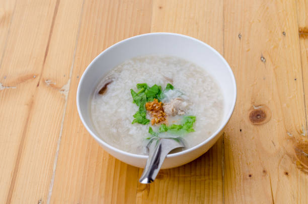 Congee with minced pork in white bowl, breakfast time