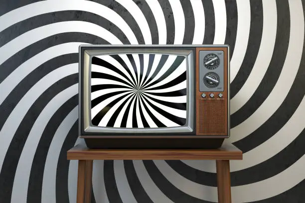 Photo of Propaganda and brainwashing of the influential mass media concept. Vintage TV set with hypnotic spiral on the screen.