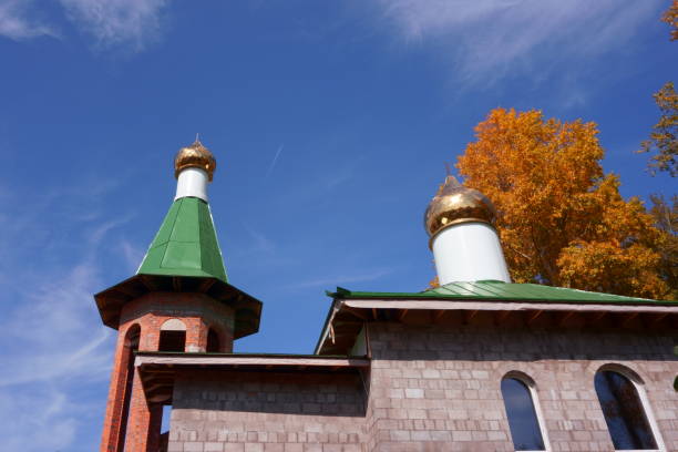 christianity unfinished church on background of autumn landscape, blue sky - cupola gold russian orthodox autumn imagens e fotografias de stock