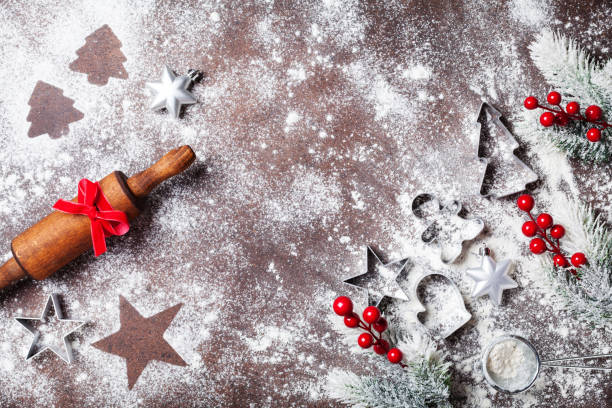 istock Christmas background for baking with flour and rolling pin decorated with fir tree top view. 1050297928