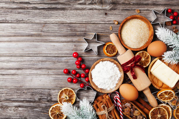 istock Bakery background with ingredients for cooking christmas baking decorated with fir tree. Flour, brown sugar, eggs and spices on rustic table top view. 1050300124