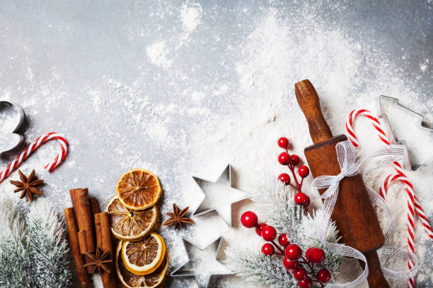 Bakery background for cooking christmas baking with rolling pin, scattered flour and spices decorated with fir tree top view. Bakery food background for cooking christmas baking with rolling pin, scattered flour and spices decorated with fir tree top view. winter food top view stock pictures, royalty-free photos & images