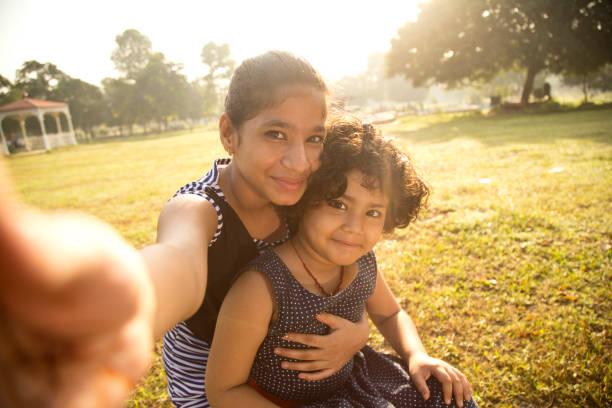 istock Girls posing for selfie at park 1050300742