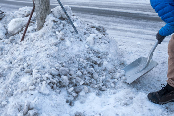 istock Man clearing snow with shovel on wayside 1050304562