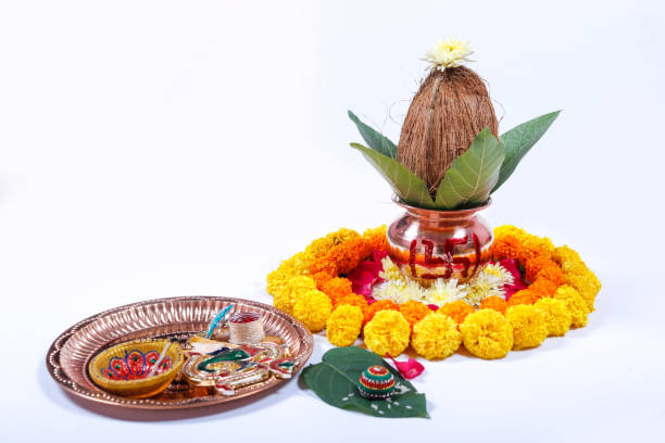 istock Copper Kalash with coconut , leaf and floral decoration on a white background. essential in hindu puja. 1050304594
