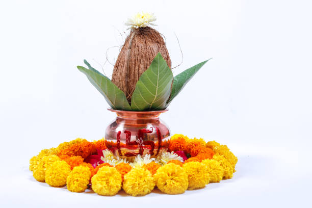 istock Copper Kalash with coconut , leaf and floral decoration on a white background. essential in hindu puja. 1050304980