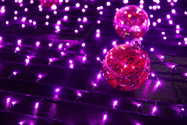 Layers of defocused, glowing circle lights sweep across a rich plum-to-orchid color gradient, infused with subtle glitter that lends modern glamour. The central copy space transforms the frame into a versatile template for cosmetics hero shots, influencer-led marketing, or holiday sale pop-ups. Balancing festive celebration with couture decoration, this abstract backdrop transitions flawlessly from Christmas gift guides to Valentine's Day  Holiday promos and spring party look-books.