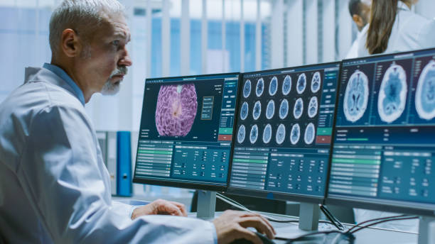 istock Senior Medical Research Scientist Working with Brain Scans on His Personal Computer. Modern Laboratory Working on Neurophysiology, Science, Neuropharmacology. Understanding Human Brain. 1050311496
