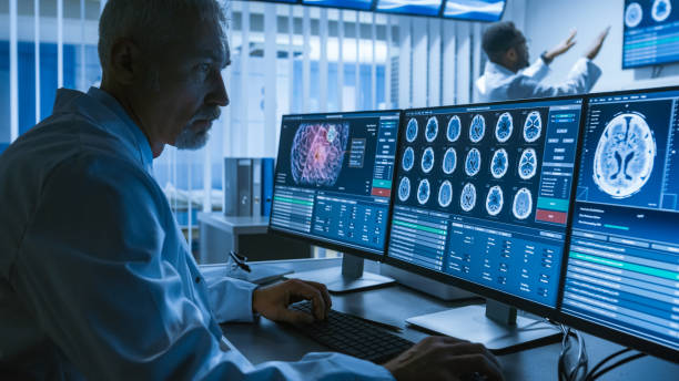 수석의 어깨 총 동안 ct 뇌 협력 의료 과학자 실험실에서 개인용 컴퓨터에서 이미지를 스캔 합니다. 연구 센터에서 신경과 뇌 종양 치료에 작동합니다. - 의료 연구 이미지 뉴스 사진 이미지