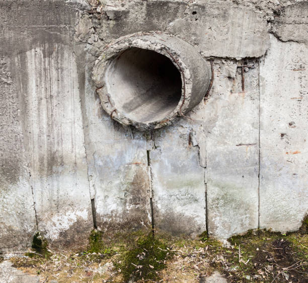 istock Concrete run-off pipe in the concrete wall. 1050315024