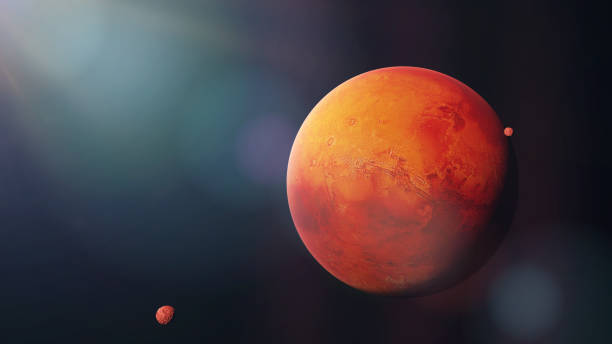 istock the red planet Mars with it moons Phobos and Deimos, part of the solar system 1050329180