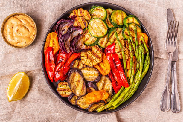 istock Grilled vegetables on a plate with sauce 1050329318