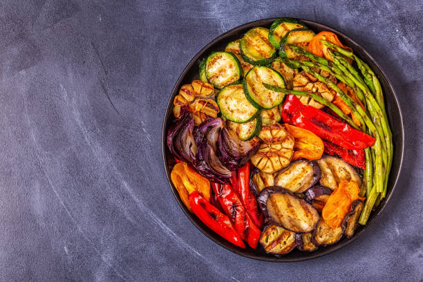 istock Grilled vegetables on a plate with sauce 1050329376
