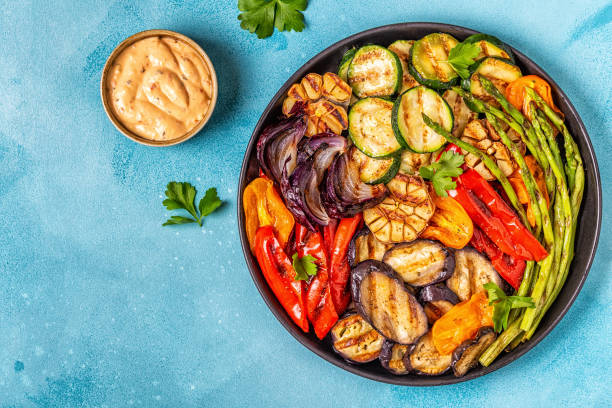 istock Grilled vegetables on a plate with sauce 1050329410